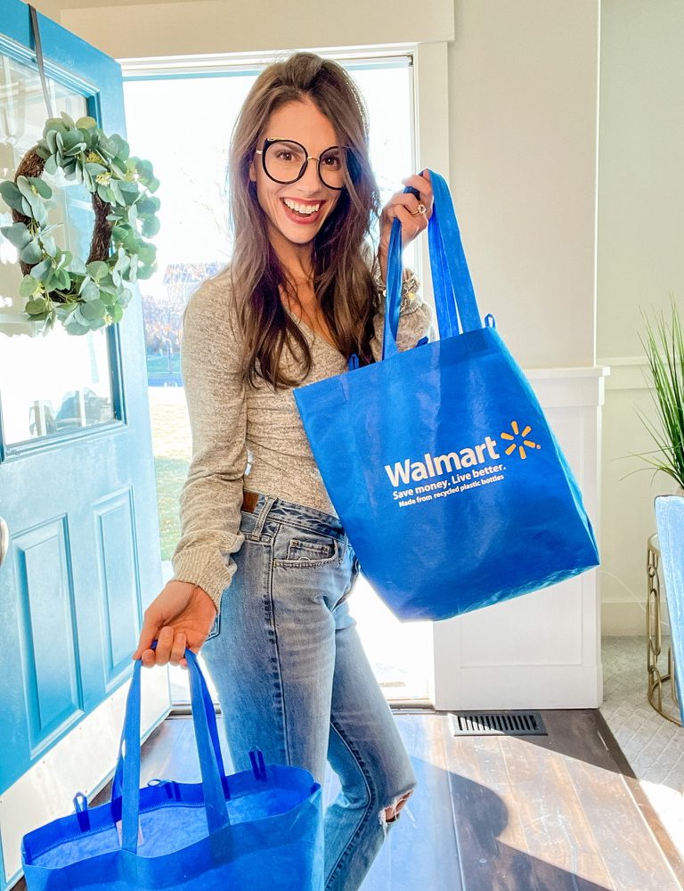 Moka holding Walmart grocery bags that were delivered using Walmart+.